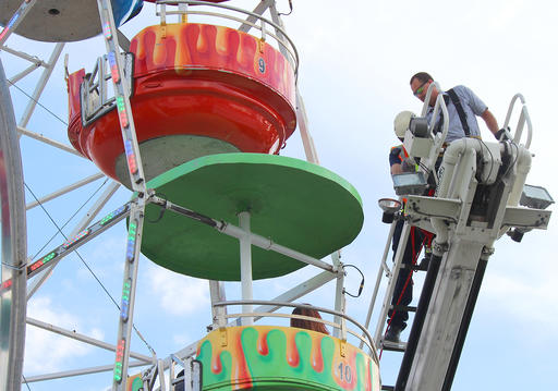 Members of the Greeneville Fire Department help people off the Ferris wheel at the Greene County Fair in Greeneville Tenn. on Monday Aug. 8 2016