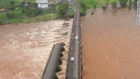 Bridge collapse sends two buses into river