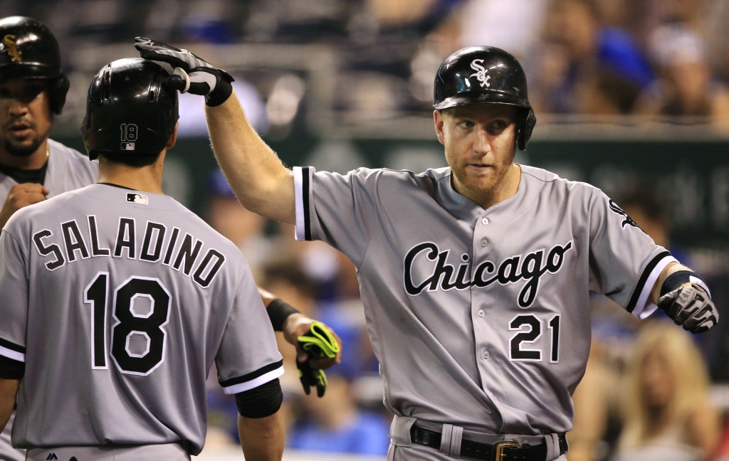 Chicago White Sox Todd Frazier pats the head of teammate Tyler Saladino after hitting a three-run home run off Kansas City Royals relief pitcher Kelvin Herrera during the tenth inning of a baseball game at Kauffman Stadium in Kansas City Mo. T