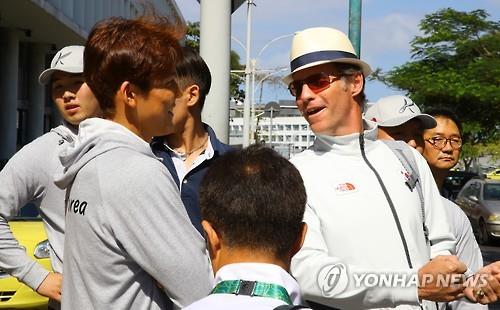 Australian swimming coach Duncan Todd speaks with his student South Korean swimmer Park Tae-hwan, after arriving in Rio de Janeiro