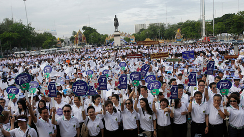 Government workers attend a rally to encourage people to vote in the upcoming referendum polling day in Bangkok Thailand