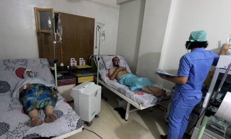 Civilians breathe through an oxygen mask at al Quds hospital after a hospital and a civil defence group said a gas what they believed to be chlorine was dropped alongside barrel bombs on a neighbourhood of the Syrian city of Aleppo