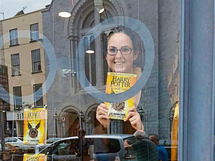 Grainne O’Brien who works in O’Mahony’s booksellers with a copy of Harry Potter and the Cursed Child