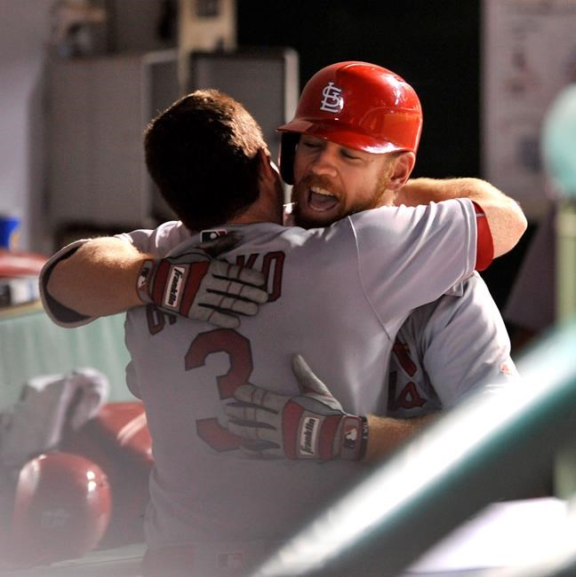 St. Louis Cardinals&#39 Brandon Moss right celebrates with teammate Jedd Gyorko in the dugout after hitting a solo home run during the eighth inning of a baseball game against the Chicago Cubs on Sunday Aug. 14 2016 in Chicago. (AP