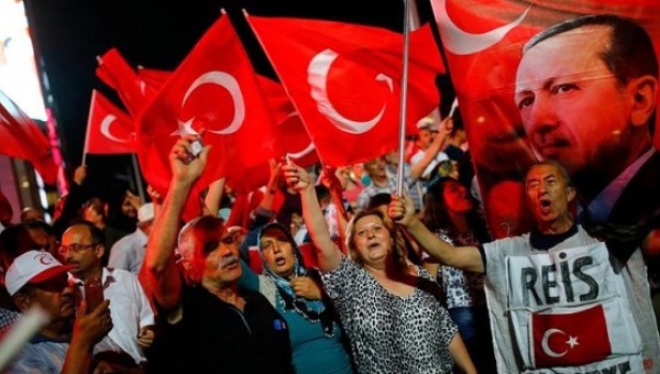 People shout slogans and wave Turkish national flags as they have gathered in solidarity night after the July 15 coup attempt in Ankara Turkey