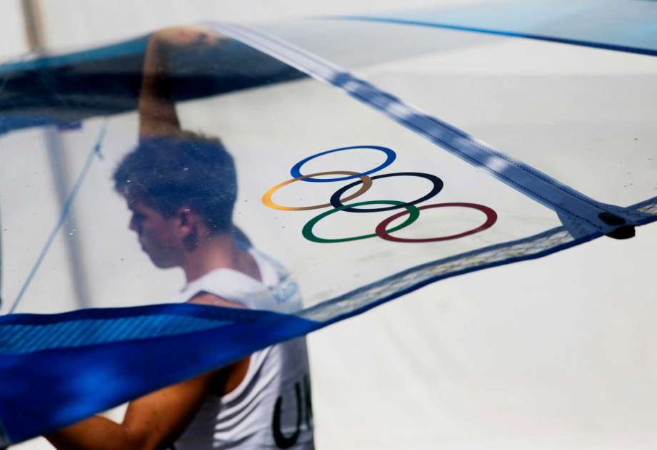 The Olympic rings decorate the sail of Ukraine's Oleksandr Tugaryev as he prepares to compete in the men's RS:X at the 2016 Summer Olympics in Rio de Janeiro Brazil Tuesday Aug. 9 2016