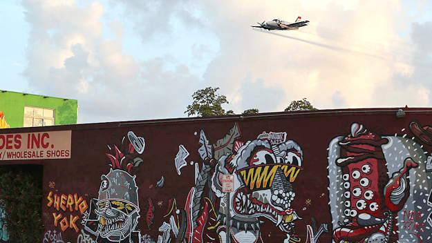 A plane sprays pesticide over the Wynwood neighborhood in the hope of controlling and reducing the number of mosquitos some of which may be capable of spreading the Zika virus