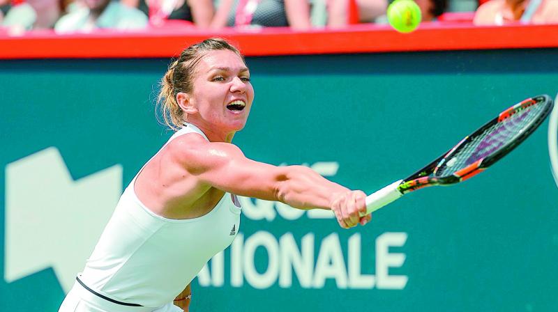 Simona Halep of Romania returns to Russia’s Svetlana Kuznetsova during their women’s singles quarterfinal at the Rogers Cup tennis tournament at Uniprix Stadium in Montreal Canada on Friday. Halep won 3-6 6-1 6-1