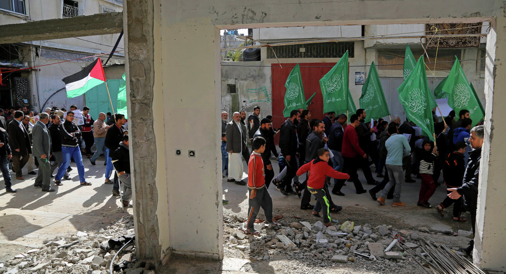 Palestinian Hamas supporters march with green Hamas and national flags in Beit Hanoun northern Gaza Strip