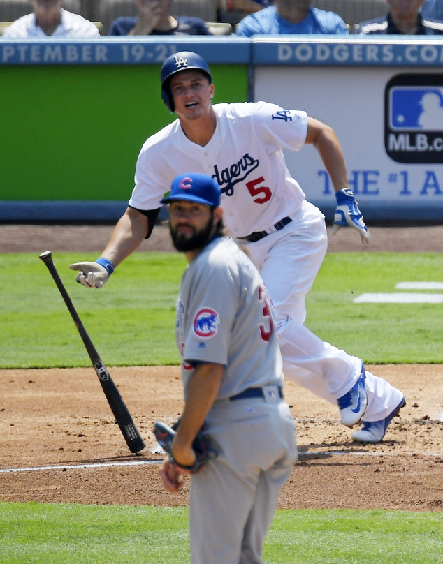 Los Angeles Dodgers Corey Seager top hits a solo home run as Chicago Cubs starting pitcher Jason Hammel watches during the first inning of a baseball game