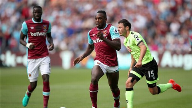 West Ham's Michail Antonio center and AFC Bournemouth's Adam Smith battle for the ball during their English Premier League soccer match at the London Stadium