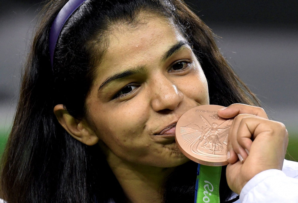 India's Sakshi Malik poses with her bronze medal for the women's wrestling freestyle 58-kg competition during the medals ceremony at the 2016 Summer Olympics in Rio de Janeiro Brazil Aug. 17