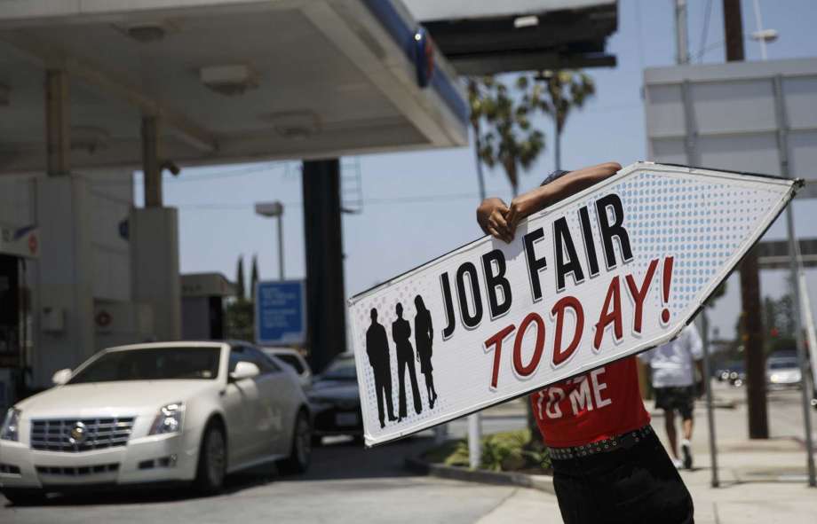 An Aarrow Sign Spinners representative spins a'Job Fair Today sign during a Choice Career Fair in Los Angeles California U.S. on Wednesday