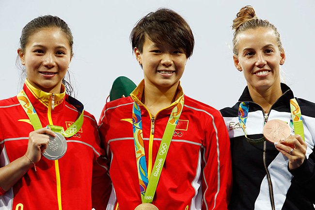 He Zi on the left with her silver medal. Image via Clive Rose  Getty Images