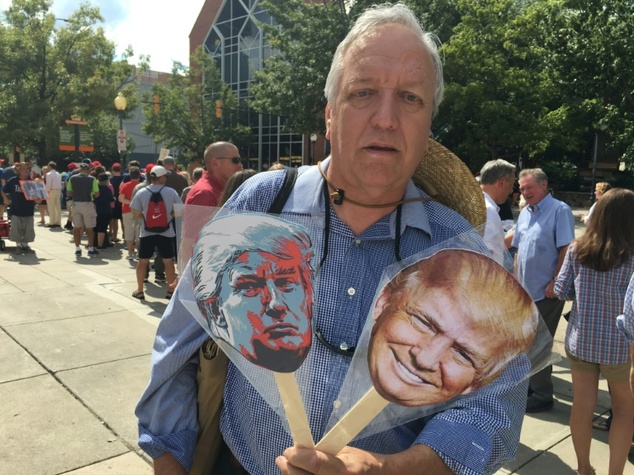 Doug Berry sells Donald Trump fans outside a campaign rally at the Charlotte North Carolina convention center