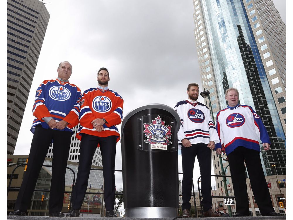 Edmonton Oilers alumnus Dave Semenko Oilers goaltender Cam Talbot Winnipeg Jets forward Blake Wheeler and Jets alumnus Thomas Steen show off the Heritage Classic jerseys as the National Hockey League announce the rosters at a Tim Hortons NHL Heritage Cl