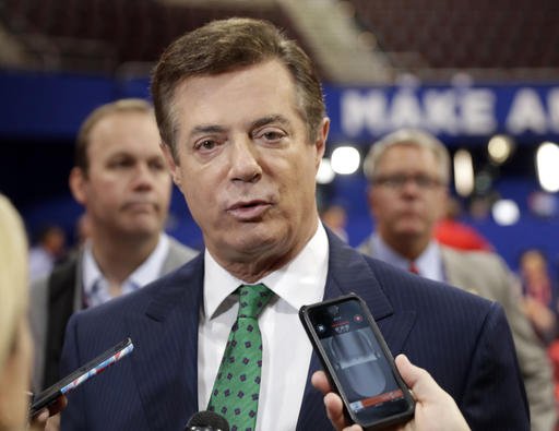 Trump Campaign Chairman Paul Manafort talks to reporters on the floor of the Republican National Convention at Quicken Loans Arena in Cleveland as Rick Gates listens at back left. Emails obtained by The Associated