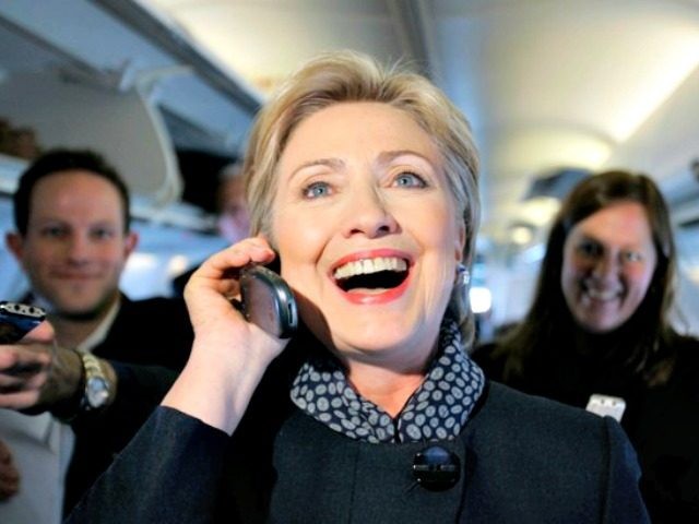 Democratic presidential hopeful Sen. Hillary Rodham Clinton D-N.Y. talk on the phone with a girlfriend of a member of the traveling press as she passed out Valentine's day chocolates aboard her campaign plane as it sat on the tarmac at the Youngst