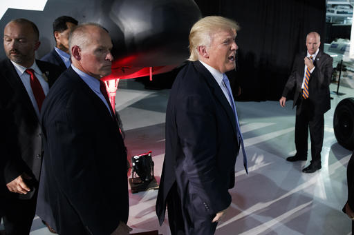 Republican presidential candidate Donald Trump walks off after speaking during a campaign rally at Wings Over the Rockies Air and Space Museum Friday