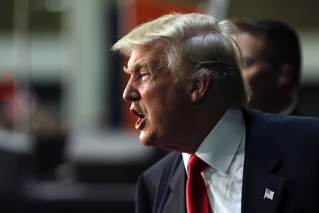 Republican presidential candidate Donald Trump calls out to supporters as he exits after speaking in Charlotte N.C