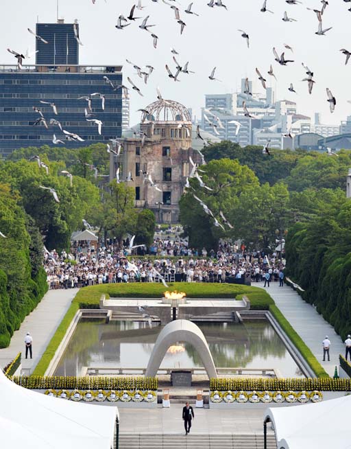 Doves fly over the cenotaph dedicated to the victims of the atomic bombing at the Hiroshima Peace Memorial Park during the ceremony to mark the 71st anniversary of the bombing in Hiroshima western Japan Saturday Aug. 6 2016. (Shingo Nishizume  Kyodo New