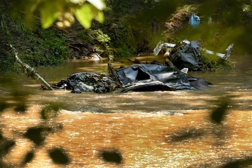 A submerged car is visible in the Patapsco River seen from the Howard County side of Patapsco Valley State Park after the sidewalk caved in due to Saturday night’s flooding in Ellicott City Md. Sunday