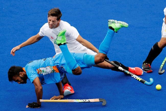 Canada's Iain Smythe top falls with India's Chandanda Thimmaiah during a men's field hockey match at the 2016 Summer Olympics in Rio de Janeiro Brazil Friday Aug. 12 2016. THE CANADIAN PRESS  AP Dario Lopez-Mills