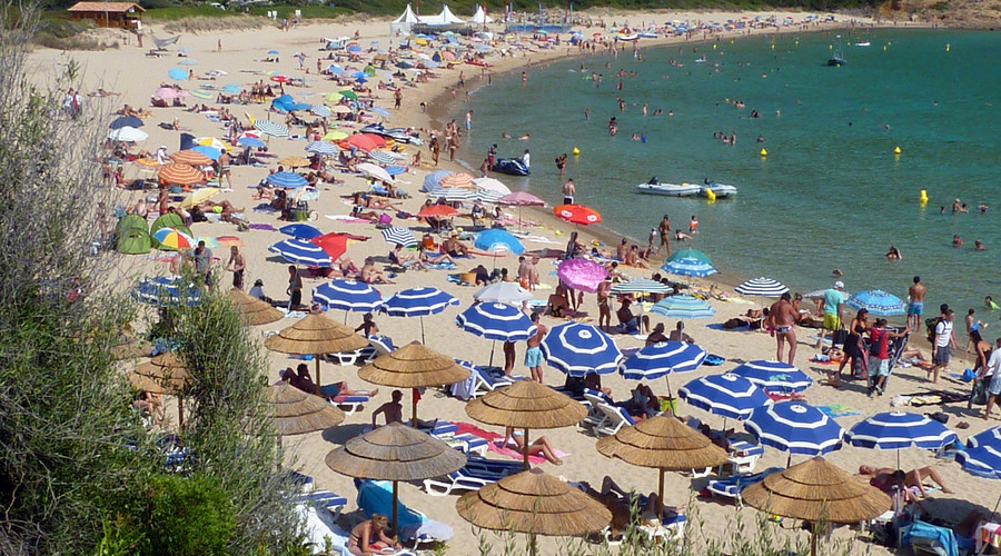 Holiday makers enjoy the high temperatures at the beach near Cargese in the French island of Corsica