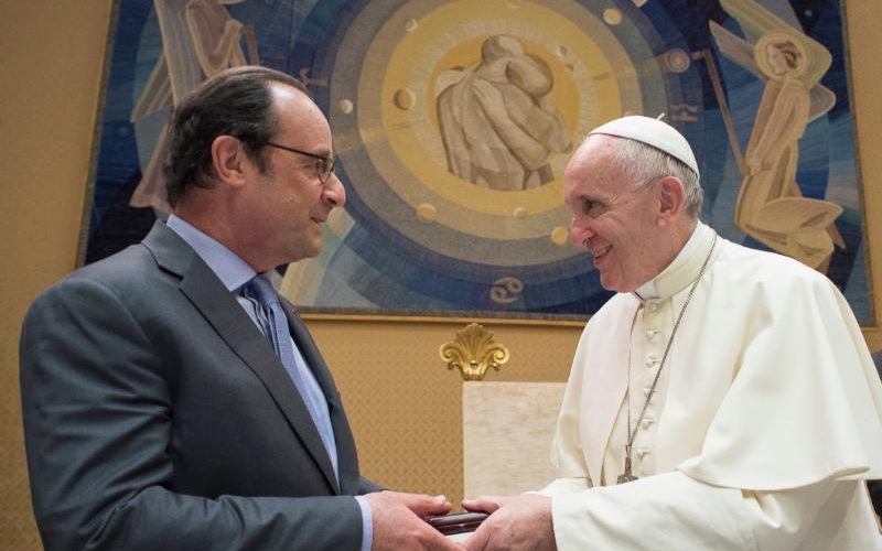 Pope Francis exchanges gifts with French President Francois Hollande at the Vatican