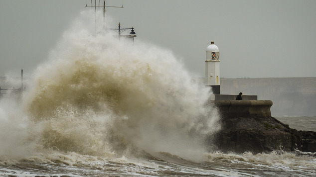 Huge waves crash against the harbour wall at Porthcawl Wales