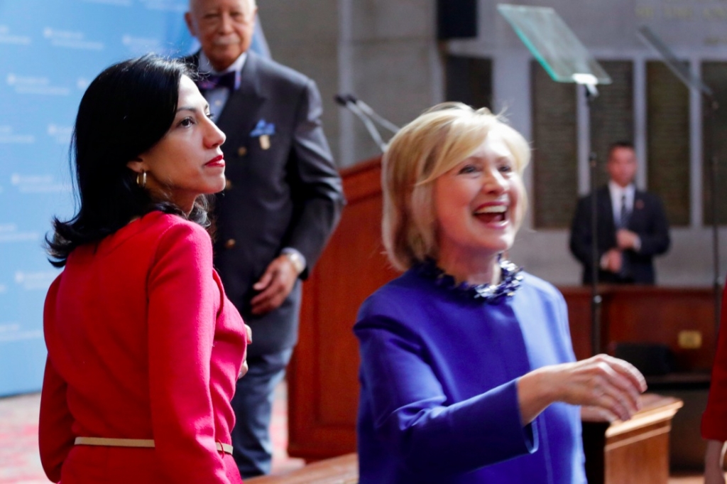 Huma Abedin left an aide to Hillary Rodham Clinton watches the Democratic presidential contender greet members of the audience following a speech at the David N. Dinkins Leadership and Public Policy Forum Wednesday