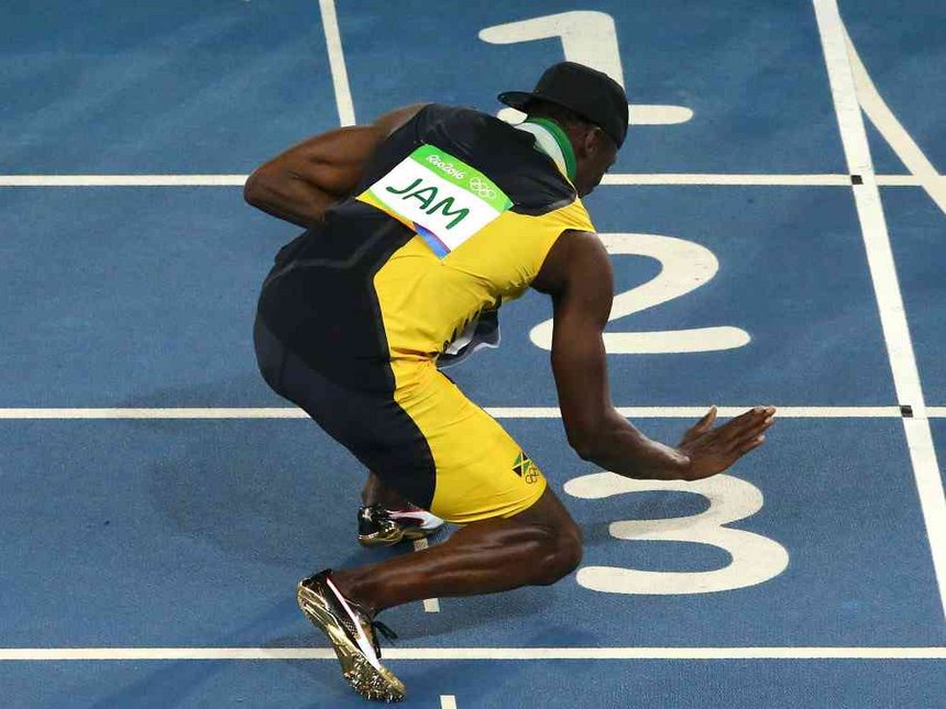 Usain Bolt of Jamaica touches the track after his team won the gold in the Men's 4 x 100m Relay Final at Olympic Stadium in Rio de Janeiro Brazil