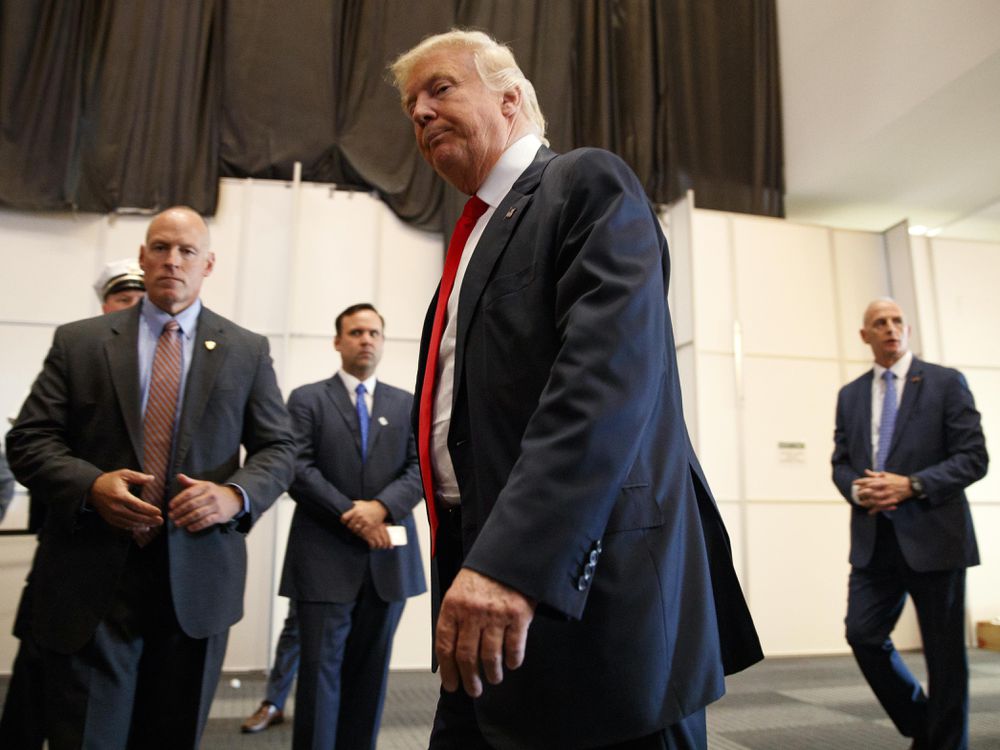 Republican presidential candidate Donald Trump walks away after speaking to reporters before a town hall event Monday Aug. 1 2016 in Columbus Ohio