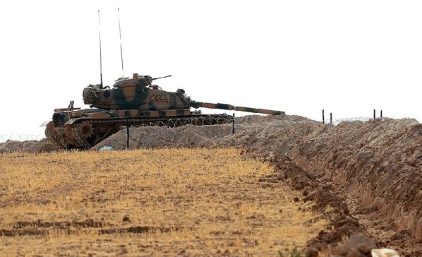 ISMAIL COSKUN						Credit AP				A Turkish tank is positioned Monday near the Syrian border in Karkamis Turkey