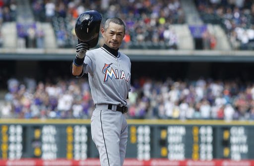 Miami Marlins Ichiro Suzuki tips his batting helmet to the crowd to acknowledge applause after he tripled off Colorado Rockies relief pitcher Chris Rusin in the seventh inning of a baseball game Sunday Aug. 7 2016 in Denver. The hit was the 3,000th