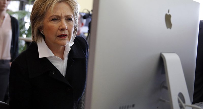 U.S. Democratic presidential candidate Hillary Clinton looks at a computer screen during a campaign stop at Atomic Object company in Grand Rapids Michigan