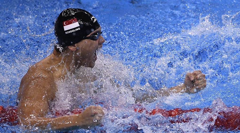 TOPSHOT- Russia's Yulia Efimova looks on USA's Lilly King celebrates winning the Women's 100m Breaststroke Final with USA's Katie Meili during the swimming event at the Rio 2016 Olympic Games at the Olympic Aquatics Stadium in Rio de Janeiro on A