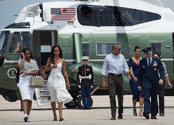 US President Barack Obama First Lady Michelle Obama and daughters Malia and Sasha walk to board Air Force One at Andrews Air Force Base in Maryland