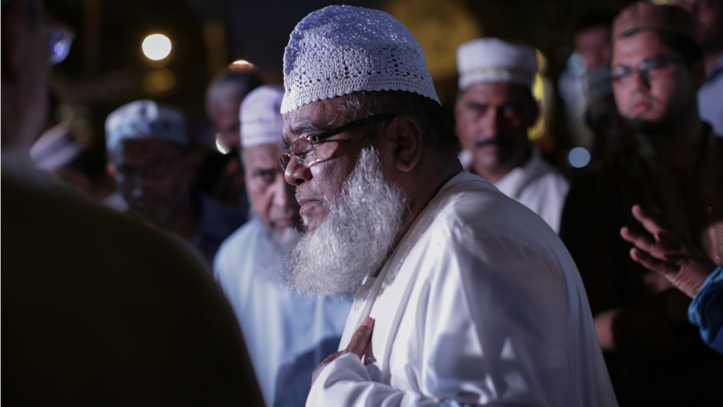 A community member speaks with members of the media outside the Al Furqan Jame Mosque in Ozone Park after Mosque leader Maulama Akonjee and friend Thara Uddin were killed in the Queens borough of New York City