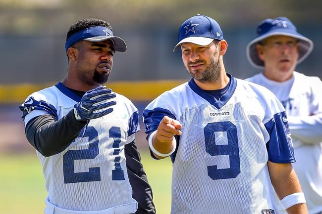 Dallas Cowboys running back Ezekiel Elliott and teammate quarterback Tony Romo talk a play over during practice at the NFL football team's training camp in Oxnard Calif. Tuesday Aug. 2 2016