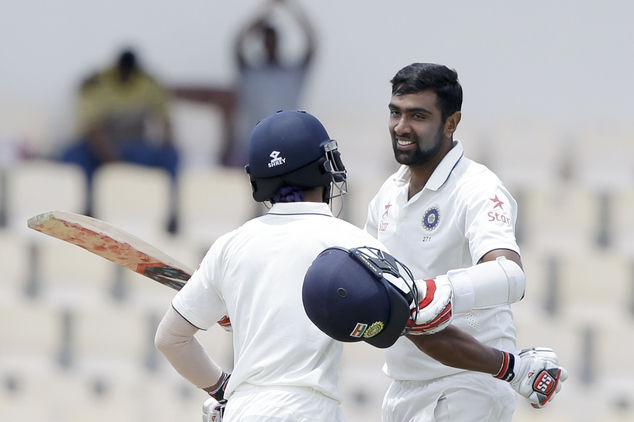 India's Ravichandran Ashwin right is embraced by teammate Wriddhiman Saha after he scoring a century against West Indies during day two of their third cric