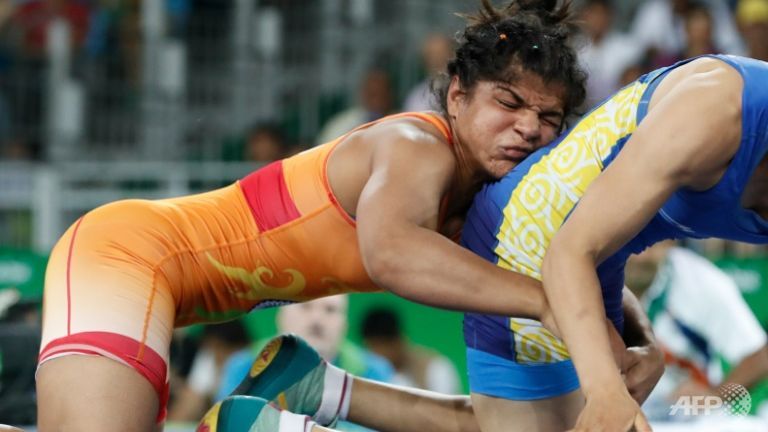 India's Sakshi Malik wrestles with Kyrghyzstan's Aisuluu Tynybekova in the women's 58kg freestyle bronze medal match