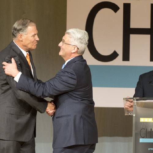 Jay Inslee left shakes hands with challenger Bill Bryant before the two debate at Spokane Falls Community College Wednesday Aug. 17 2016 in Spokane Wash. Moderator Sean Owsley of KHQ-TV stands at right. (Jesse Tinsley  The Sp