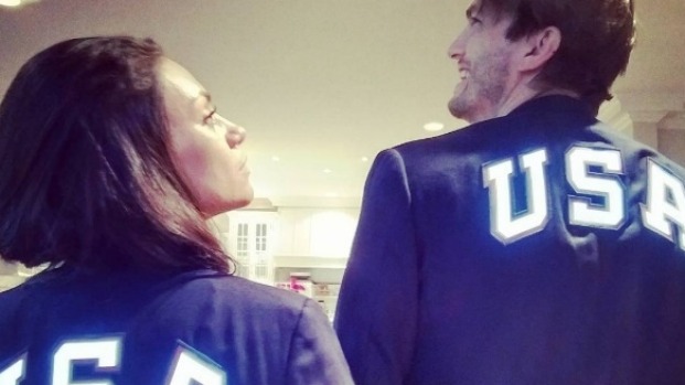 Armchair Olympians Mila Kunis and Ashton Kutcher strike a pose in their matching outfits