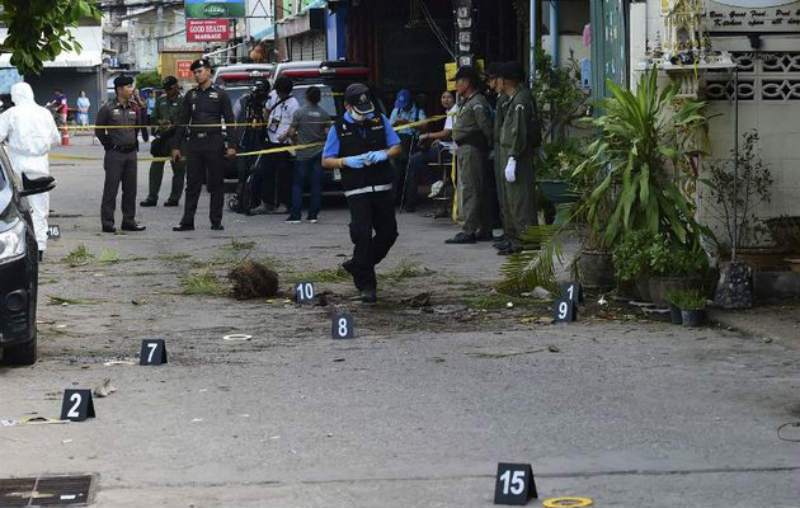 Investigation officials collect evidence from the crime scene after a small bomb exploded in Hua Hin