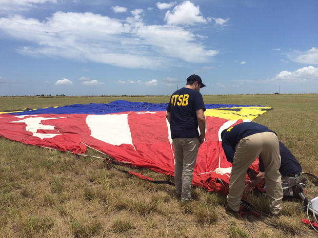 Investigators look over a hot air balloon that crashed in Central Texas