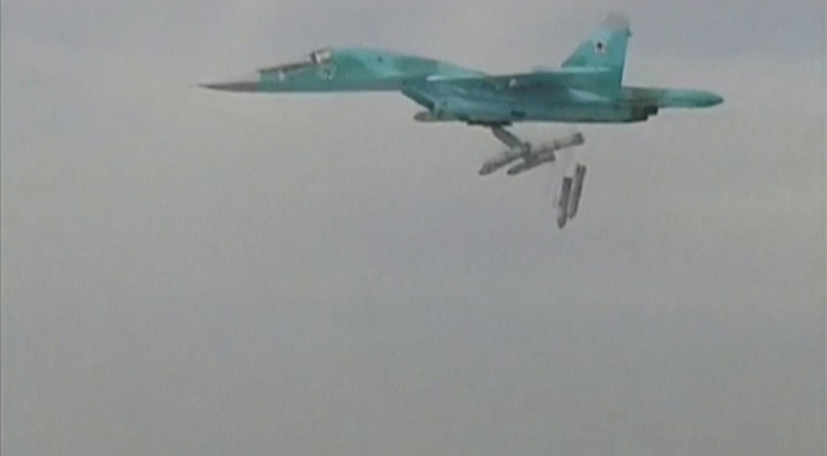 A still image taken from video and released by Russia's Defence Ministry shows a Russian Sukhoi Su-34 fighter-bomber based at Iran's Hamadan air base dropping bombs in Syria