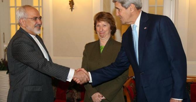 Iranian Foreign Minister Mohammad Javad Zarif shakes hands with US Secretary of State John Kerry as former EU Foreign Policy Chief Catherine Ashton looks on at nuclear talks in Vienna