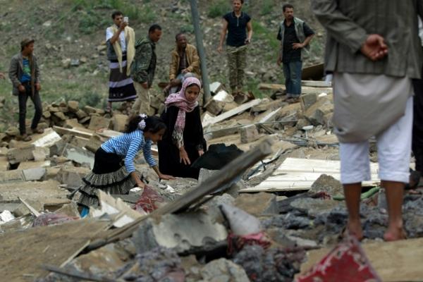 Yemenis inspect the rubble of a house in the rebel-held capital Sanaa