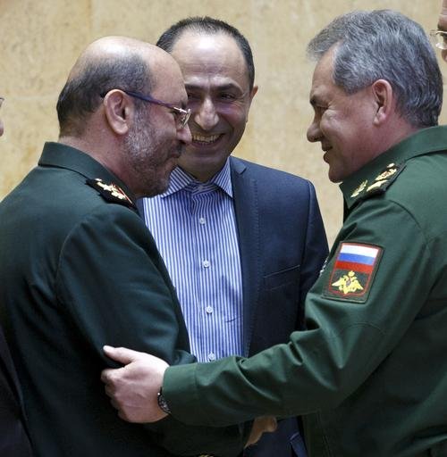 Russian Defense Minister Sergei Shoigu right and Iranian Defense Minister Gen. Hossein Dehghan shake hands during their meeting in Moscow Russia. Dehghan was quoted by Iranian State TV website Monday Aug. 22